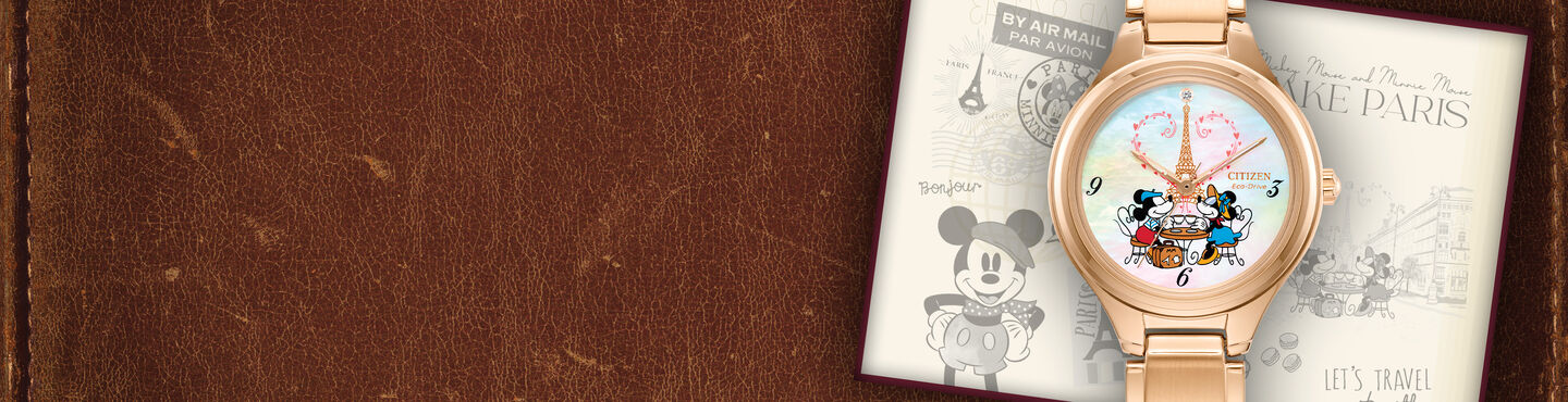 Women's Disney Watches; Featuring Mickey Mouse & Minnie Mouse Take Paris watch model FE2103-52D on a leather background
